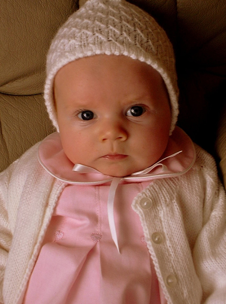 Reborn baby girl doll wearing a knitted cap