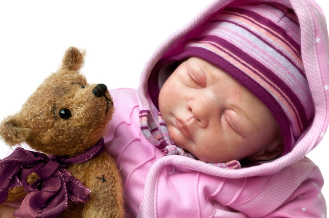 Reborn doll holding a teddy bear